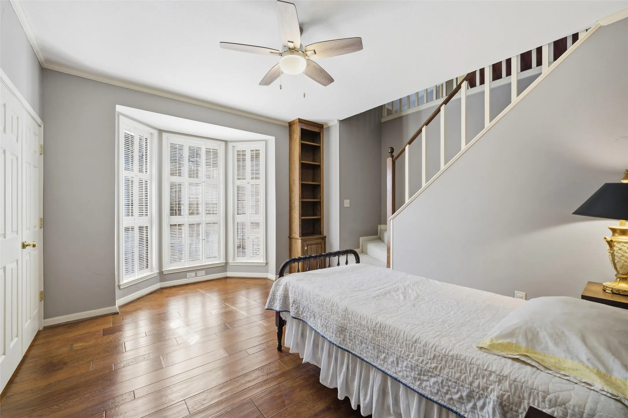 Bedroom with ceiling fan and hardwood / wood-style floors