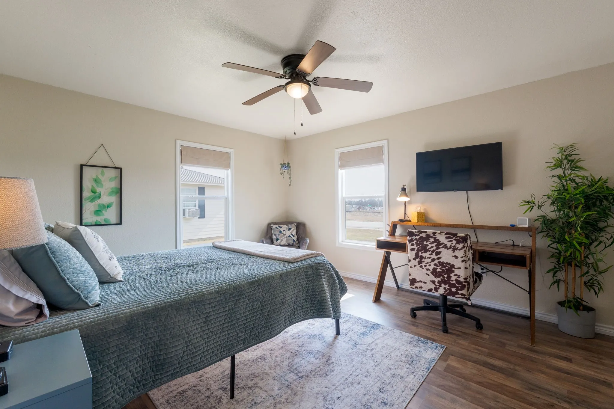 Bedroom with dark wood-type flooring and ceiling fan