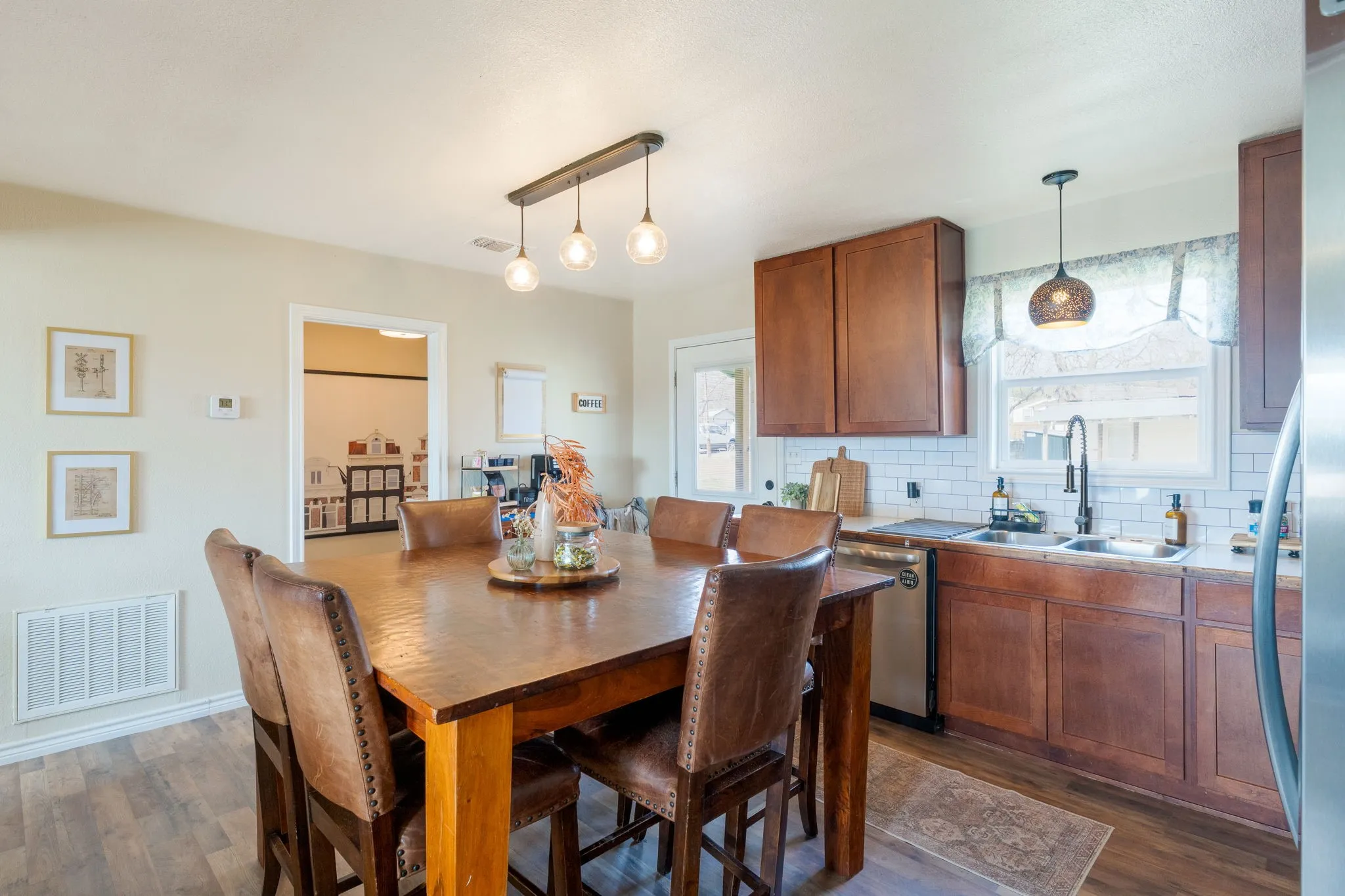 Dining area with dark wood finished floors and baseboards