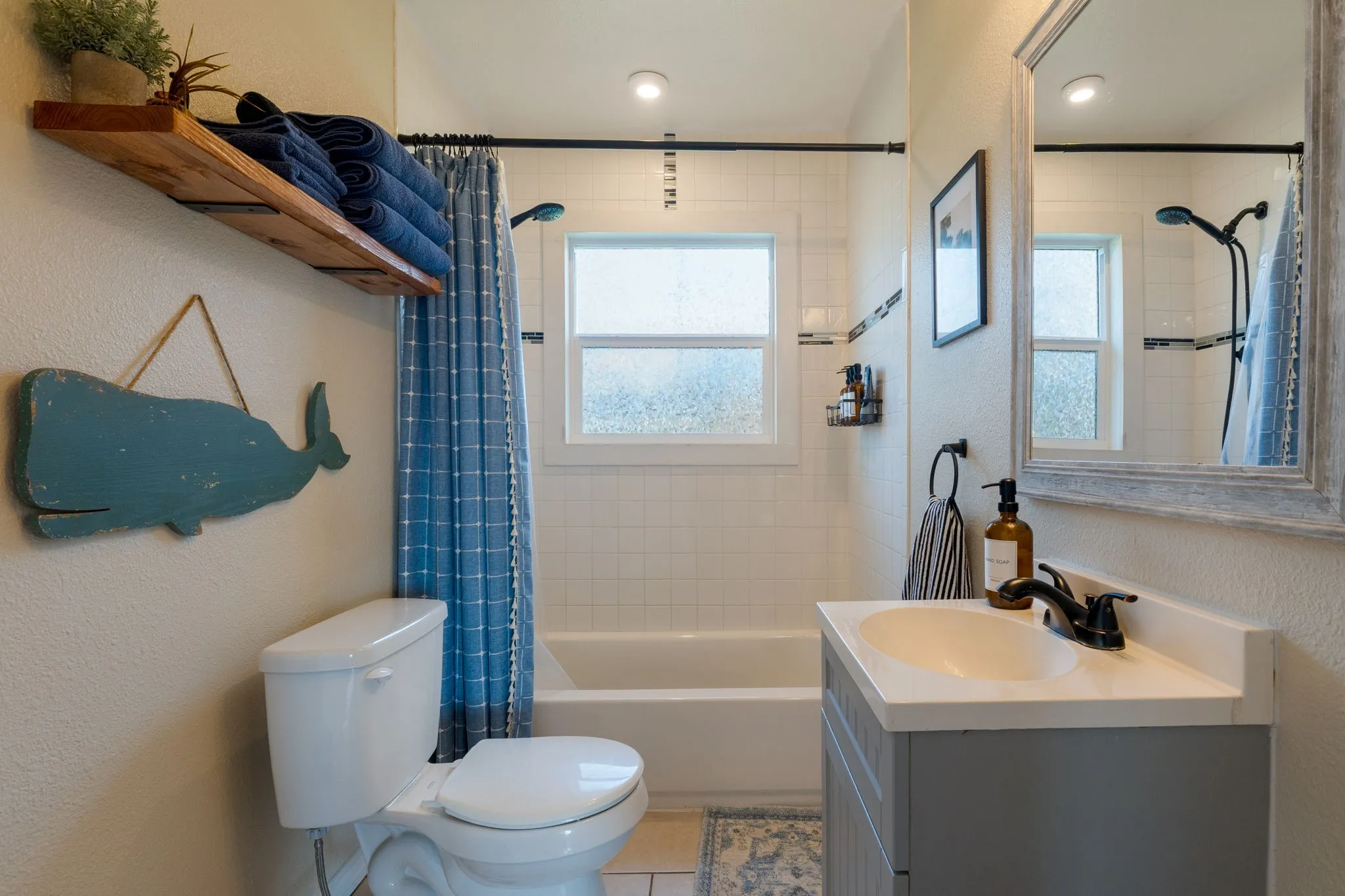 Full bathroom featuring a textured wall, vanity, shower / bathtub combination with curtain, light tile patterned flooring, and recessed lighting