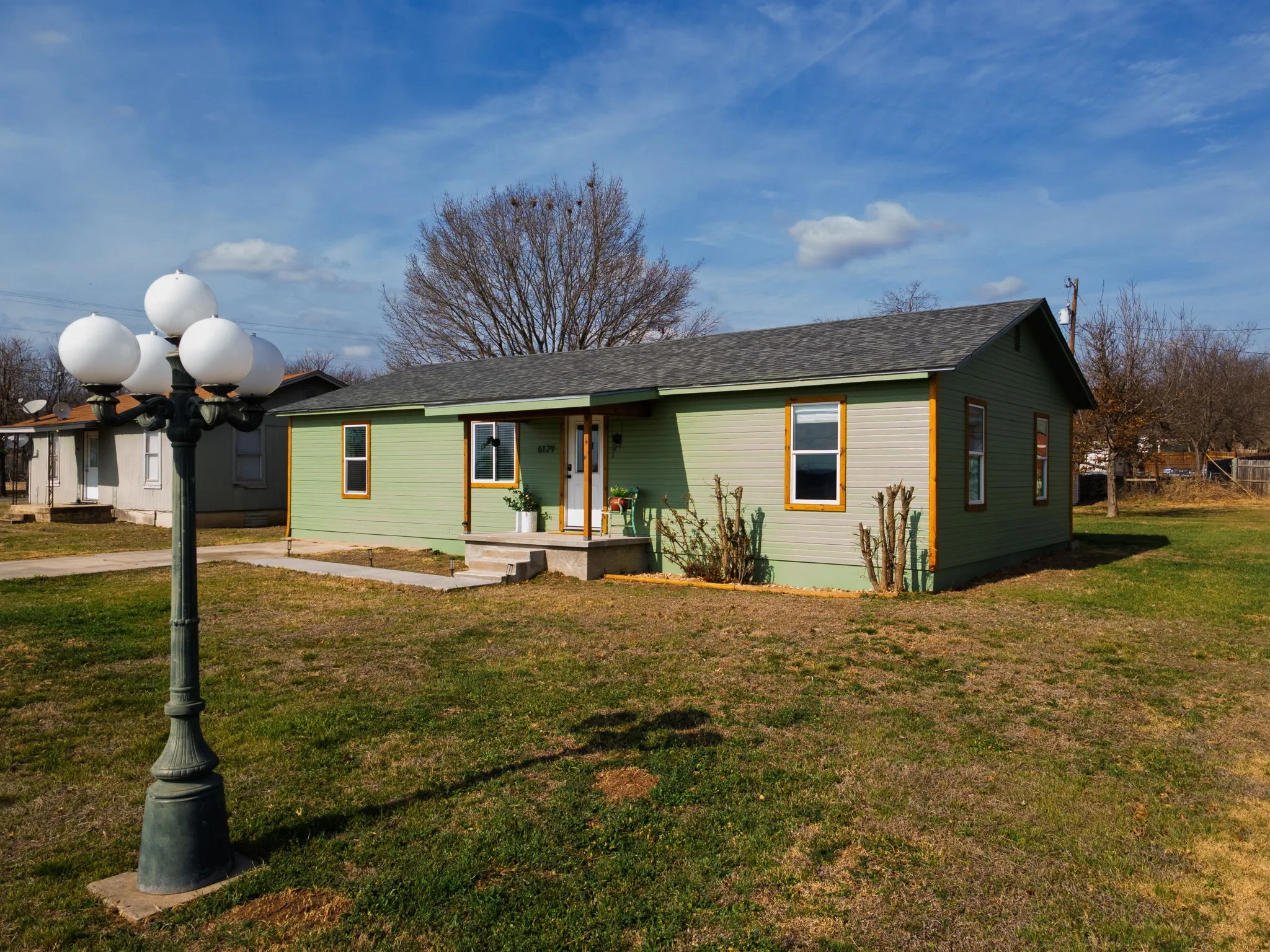 Single story home with a front lawn and a porch