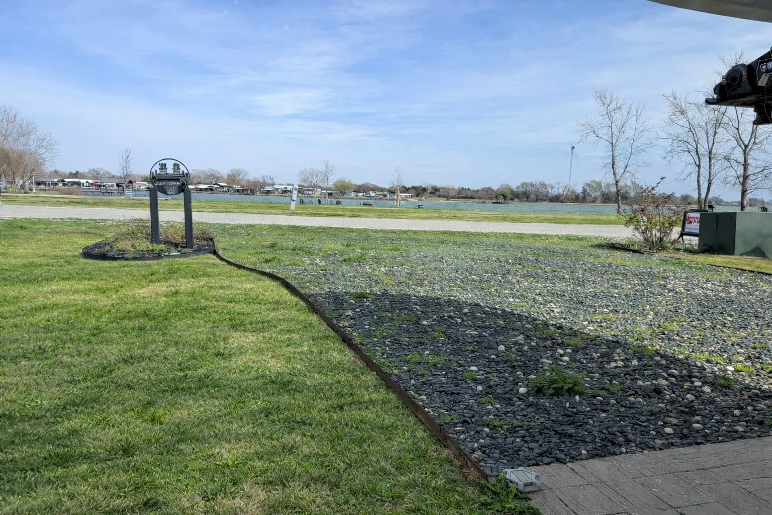 Lake-view gravel parking area and improved waterfront lot features.