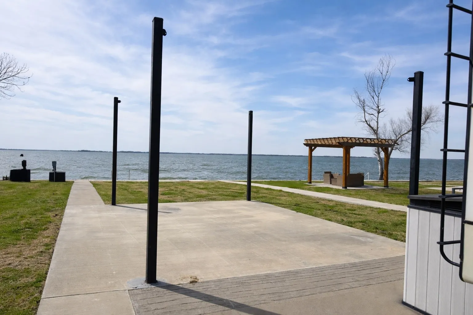 Shade sail covered patio space overlooking the waterfront near Dallas.