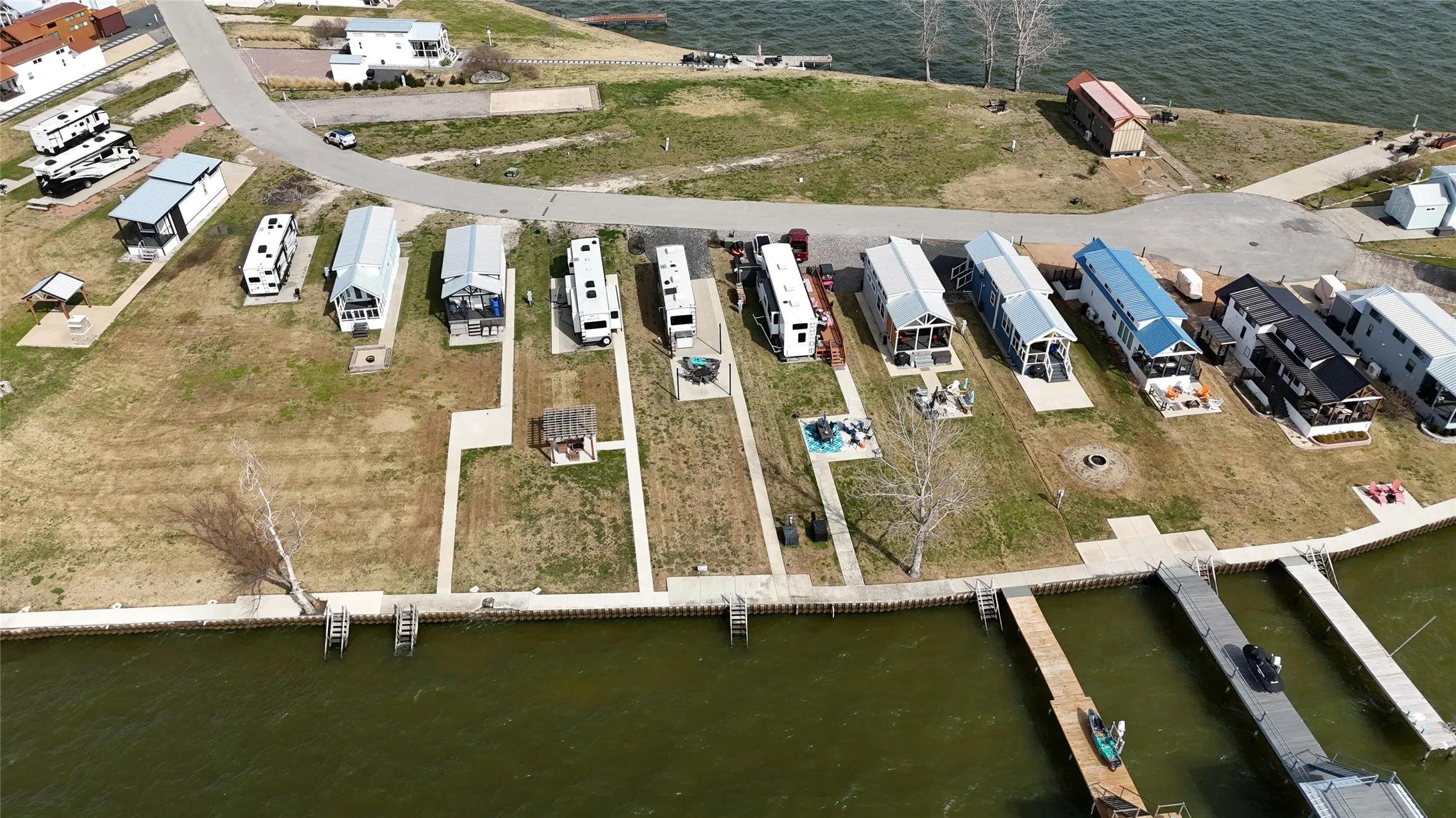 Lakefront lot with steel retaining wall and paved waterfront access.