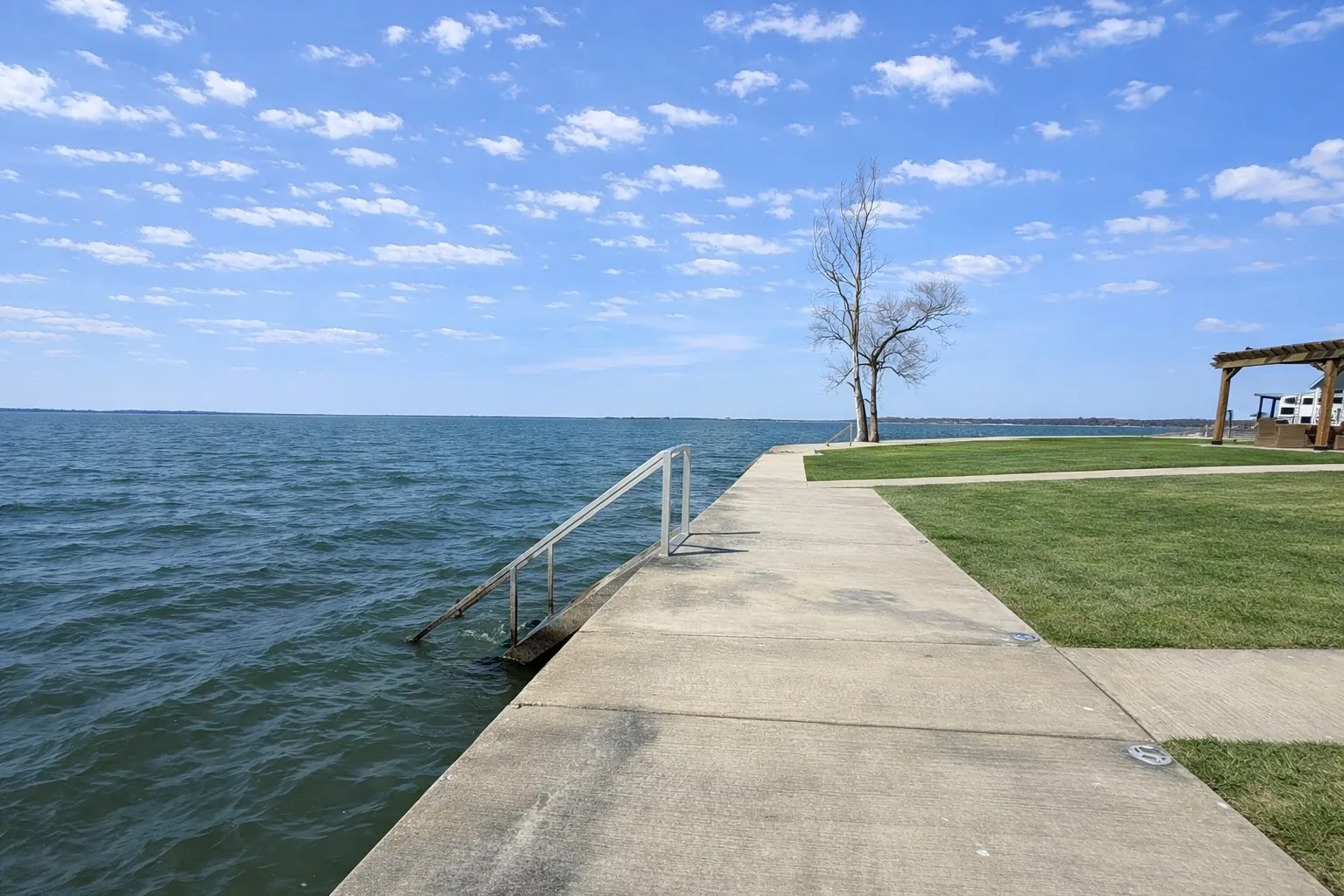 Waterfront lot with sidewalk access and green space in Kerens.