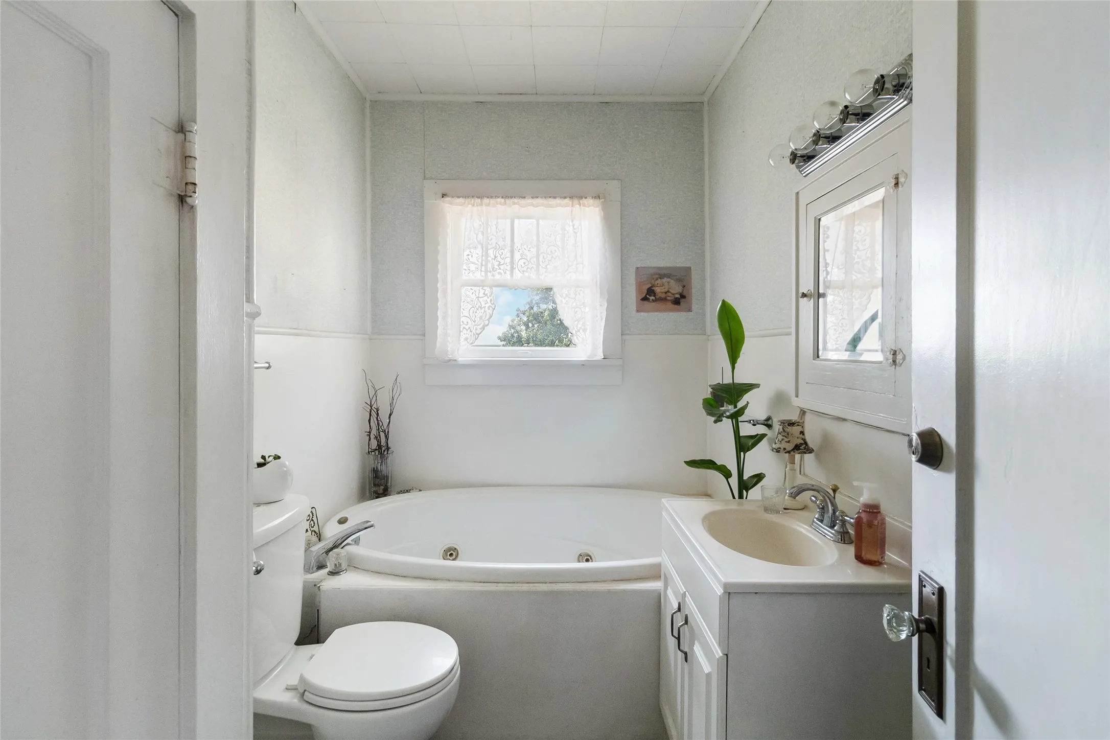 Bathroom featuring a jetted tub and vanity