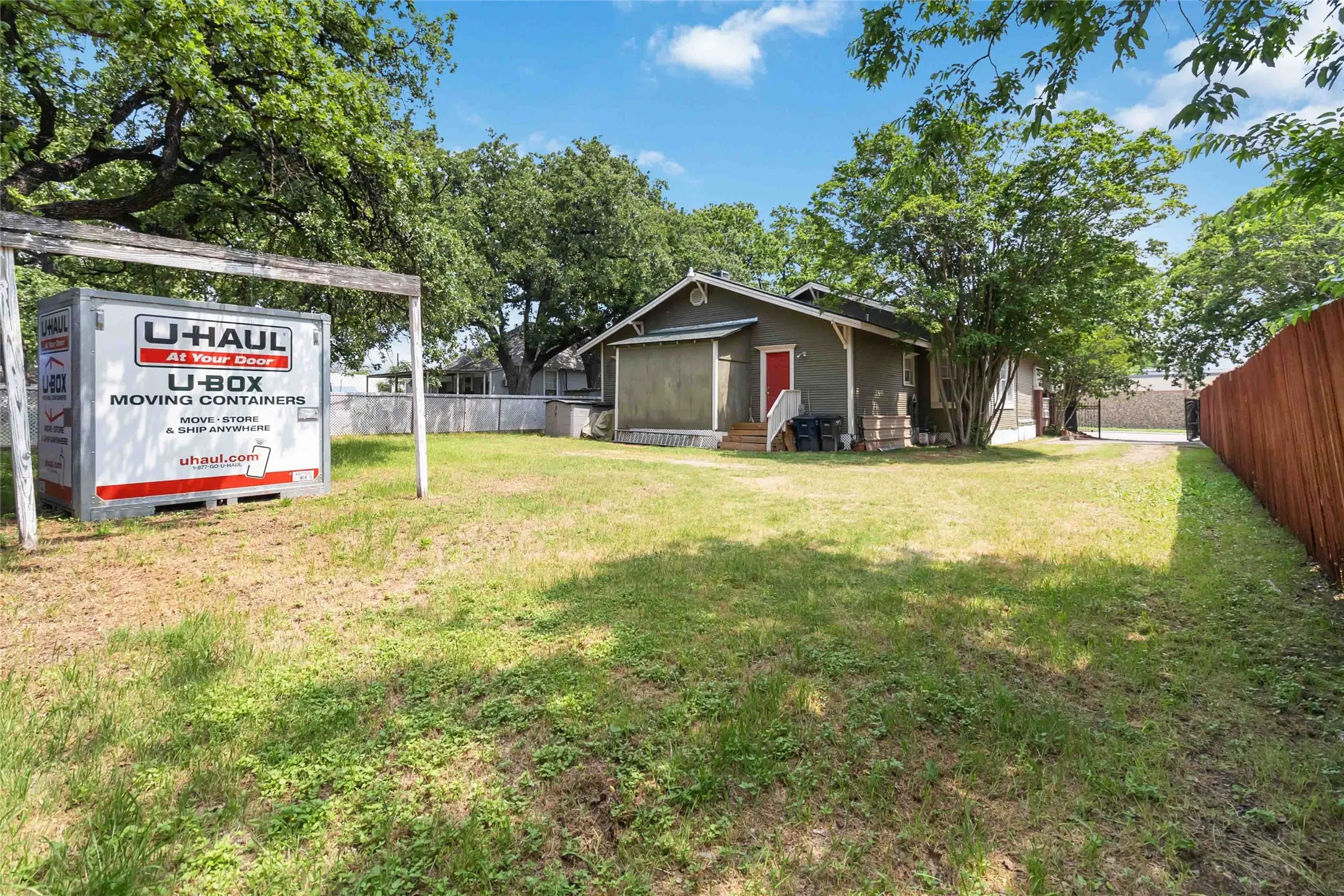 Fenced yard featuring entry steps