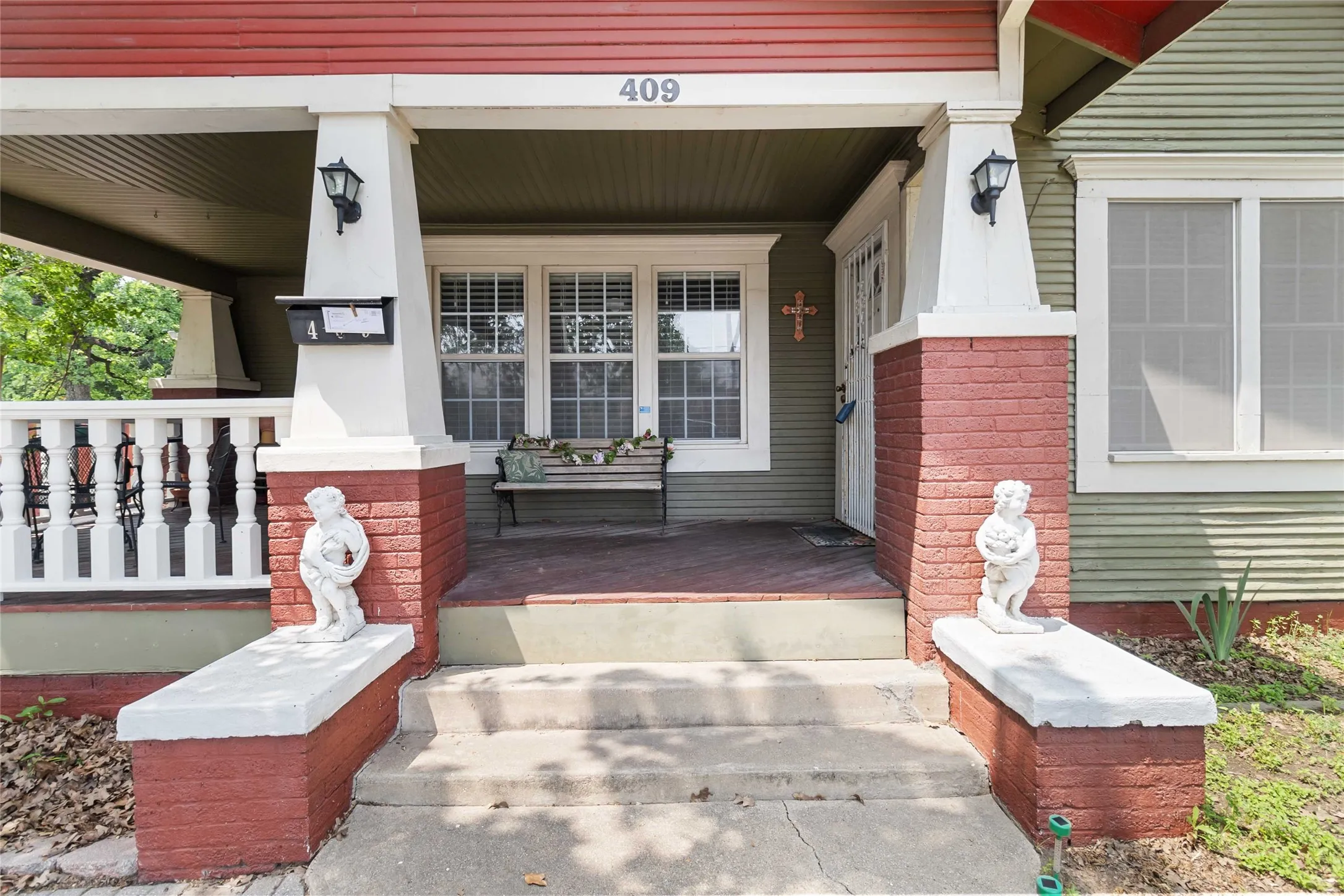 Property entrance featuring a porch and brick siding