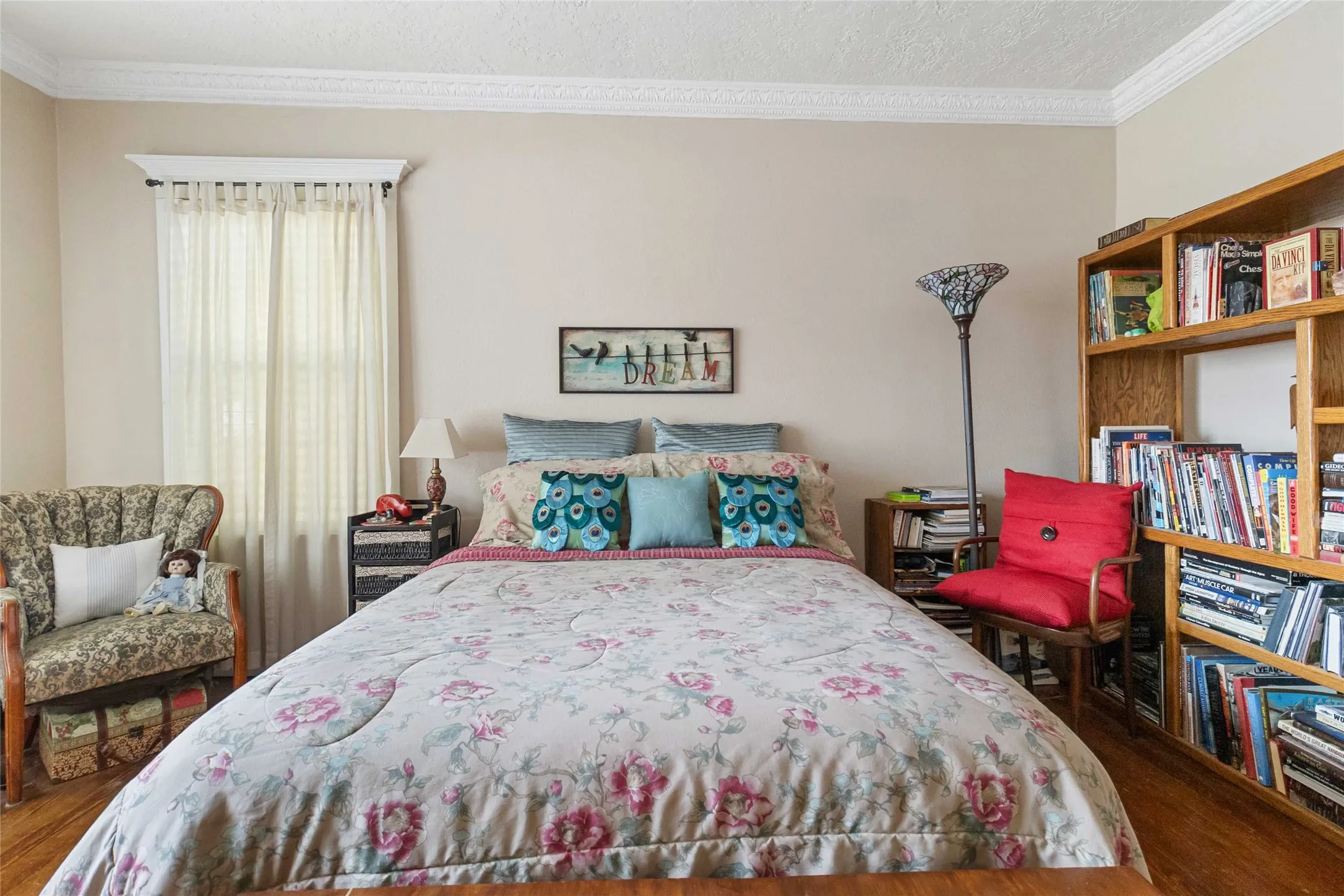 Bedroom featuring dark wood-style flooring, crown molding, and a textured ceiling