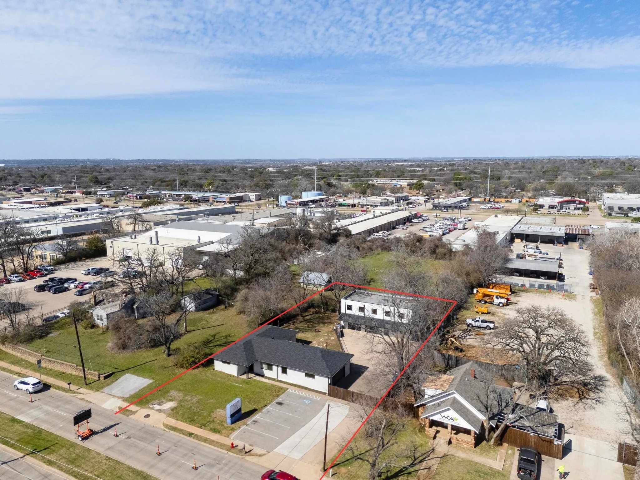 This listing is selling both Commercial buildings with the yard space in the middle and the parking in front.