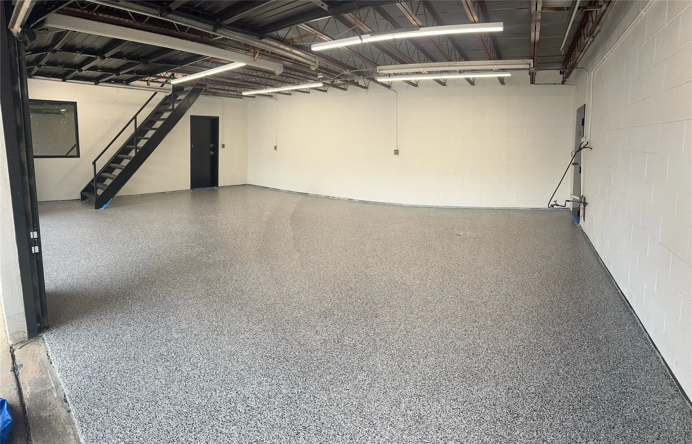 Stairs and concrete block wall, first story of the shop.