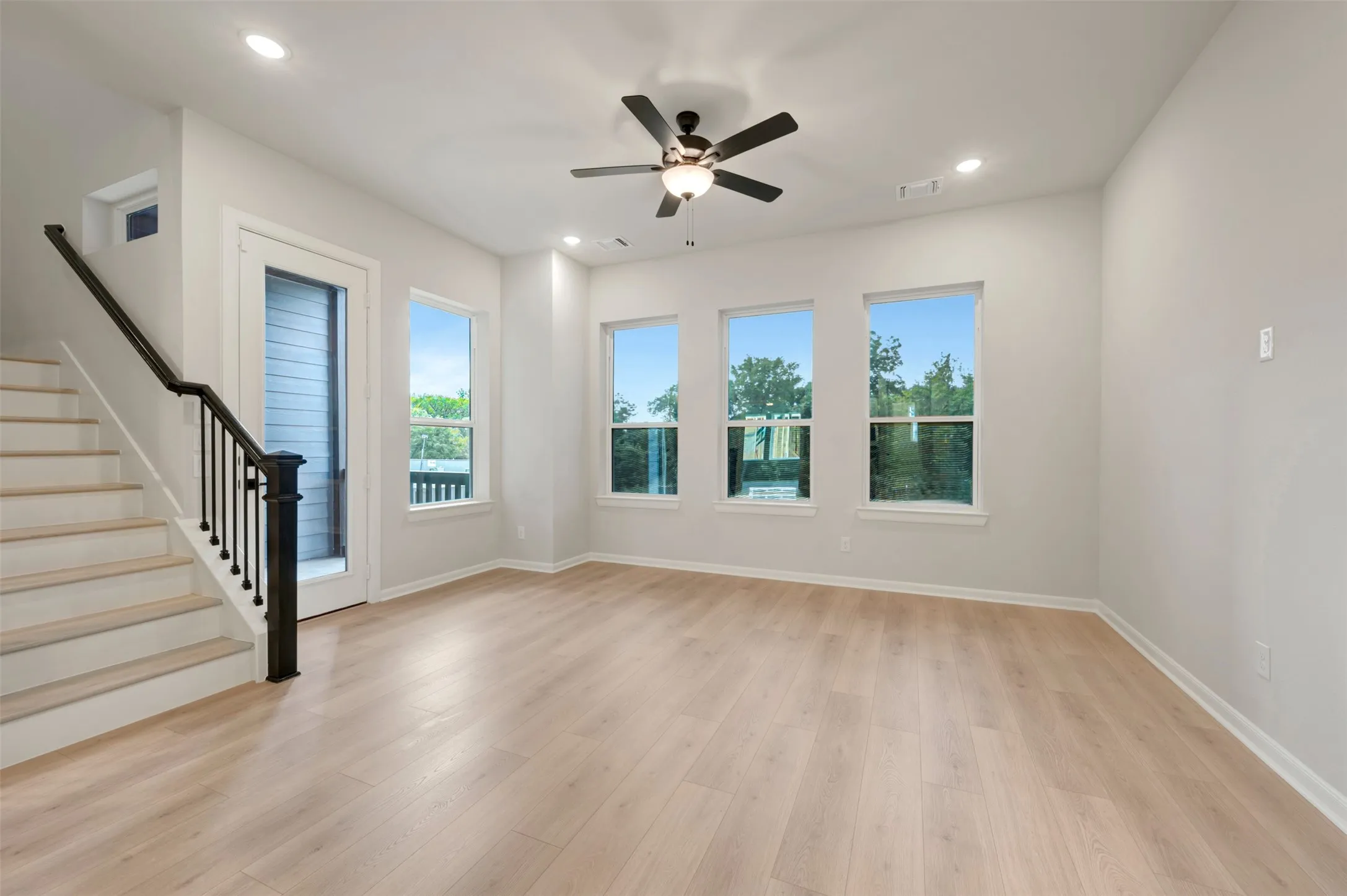 Light wood-finish flooring, recessed lighting, and a ceiling fan with light