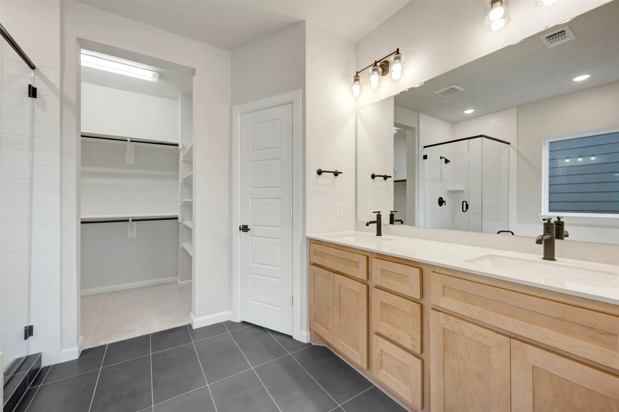 Dual vanity with integrated sinks and bronze-finish fixtures