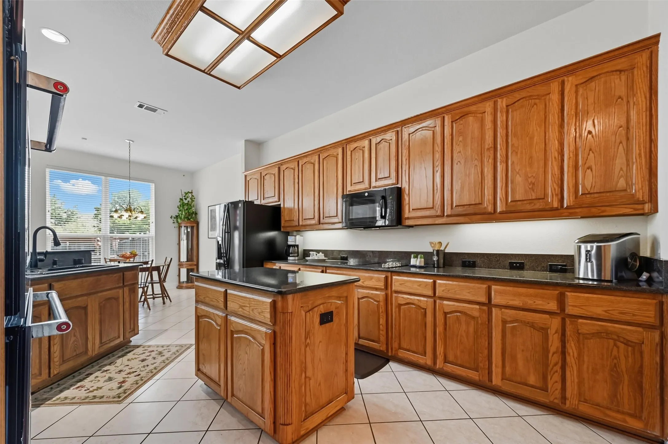 Another view of the expansive kitchen showcasing abundant cabinetry, generous countertop space, and a functional layout designed for both everyday living and entertaining.