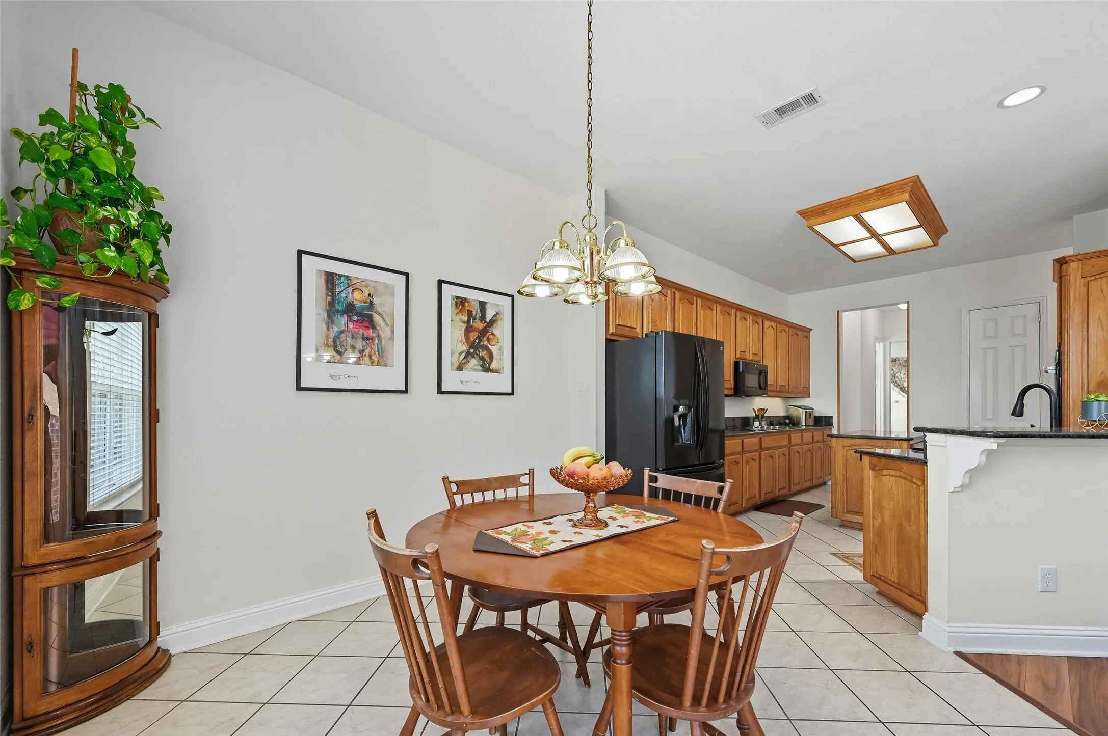 Bright breakfast nook open to both the kitchen and living area, offering a seamless flow for everyday living and easy access to the backyard for indoor-outdoor entertaining.