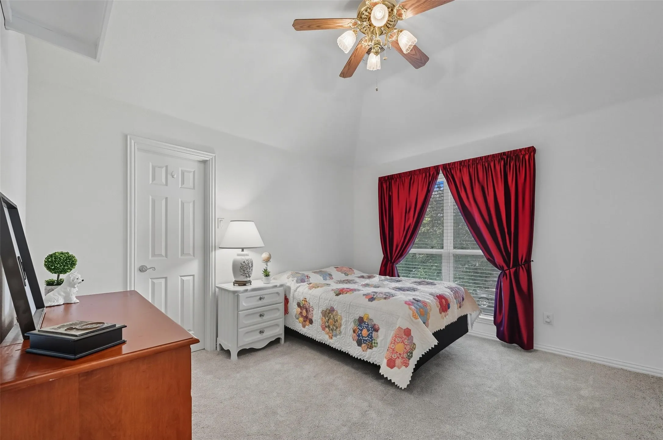 Spacious upstairs bedroom featuring a walk-in closet and convenient display shelving above the entry door for added character and storage.