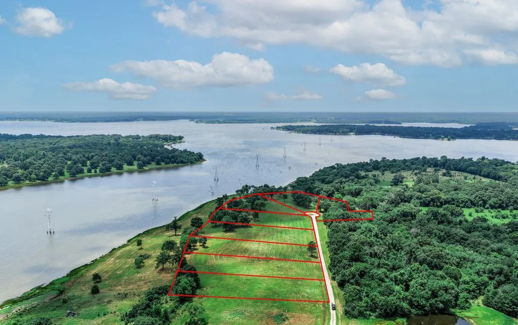 Lot Lines Approximate. Expansive waterfront parcels featuring cleared land, mature trees, and a private road