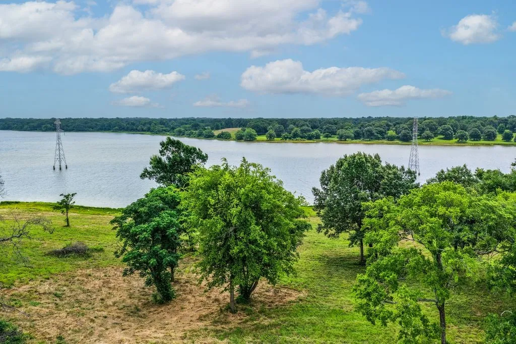 Lot 6 Expansive waterscape bordered by a verdant tree line and open land