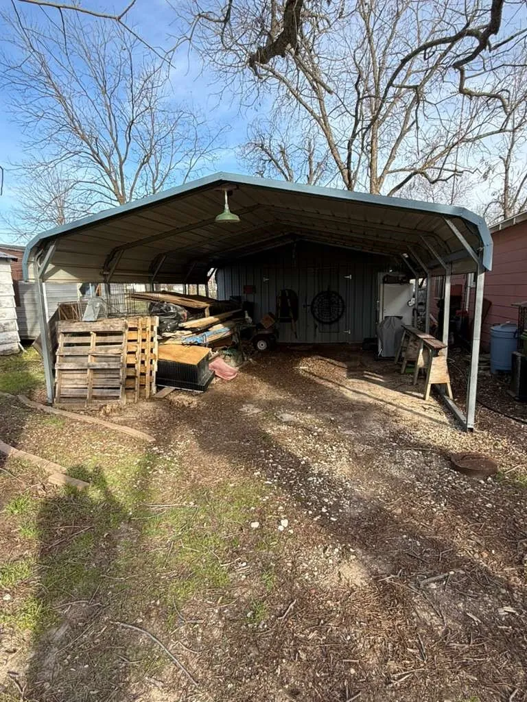 View of parking with a carport