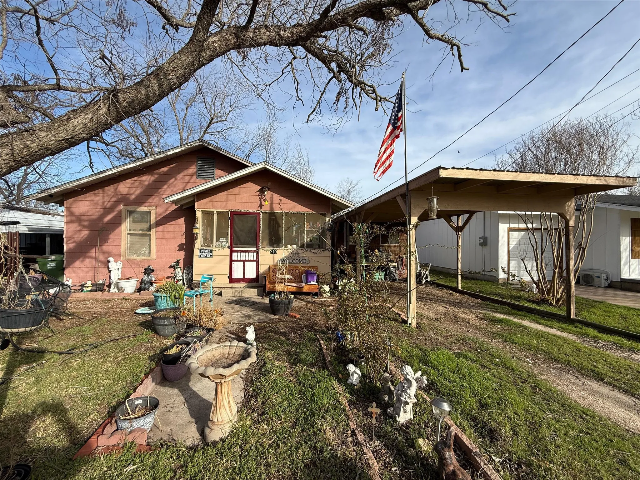 Back of property with a lawn and a patio