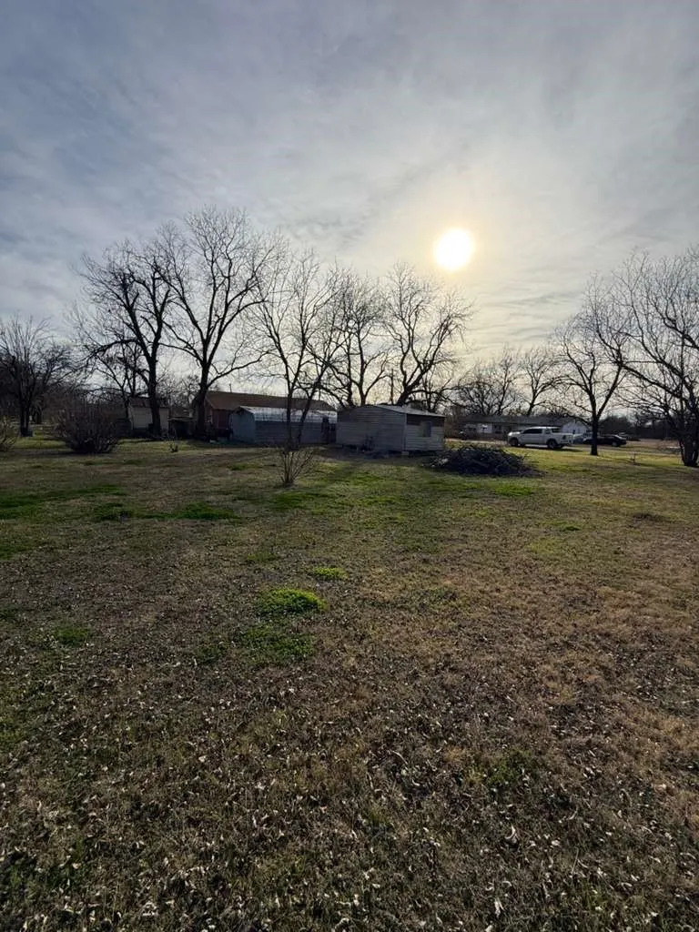 Yard at dusk featuring a yard