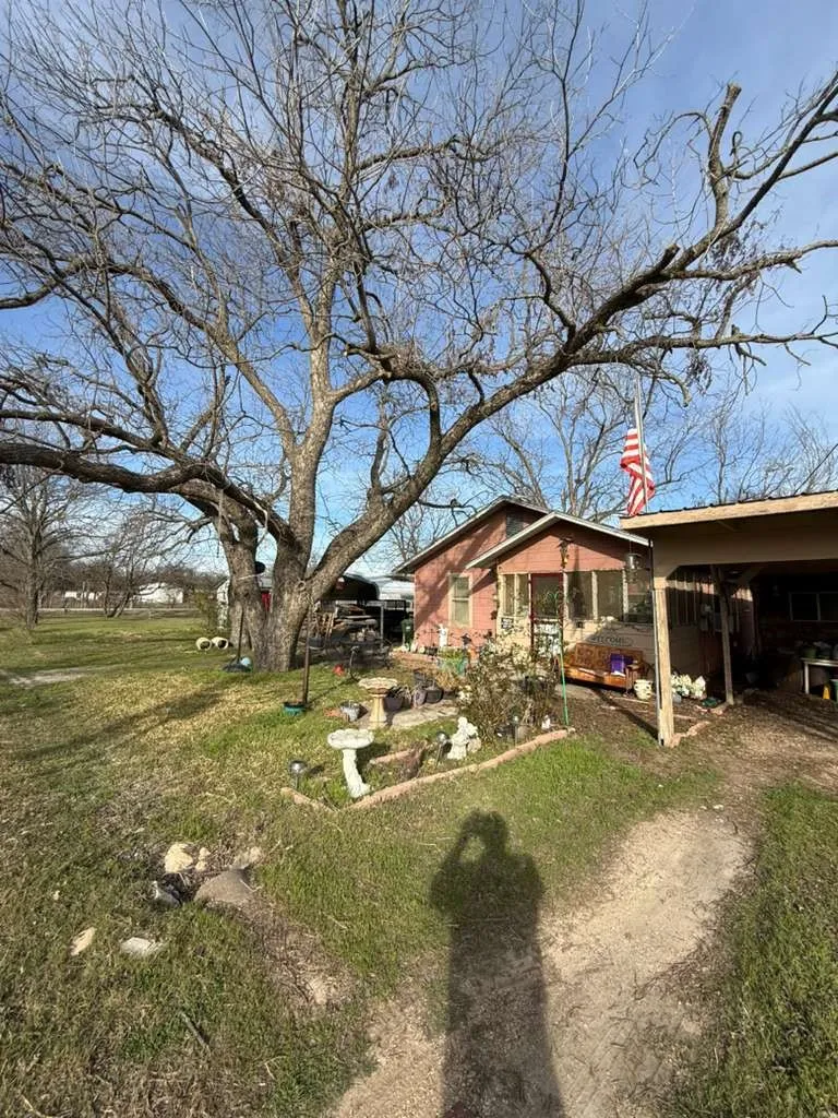View of side of property featuring a yard