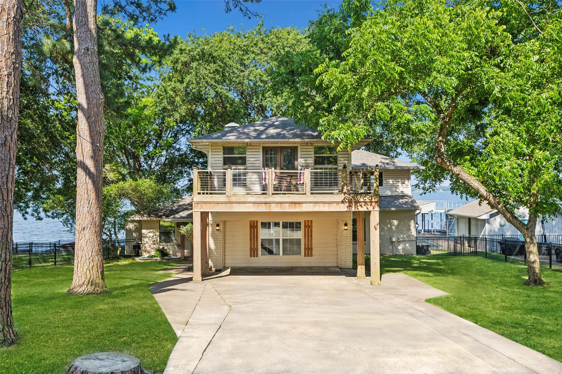 Welcoming lake front property with 2 car covered parking, balcony mature trees and gated yard.