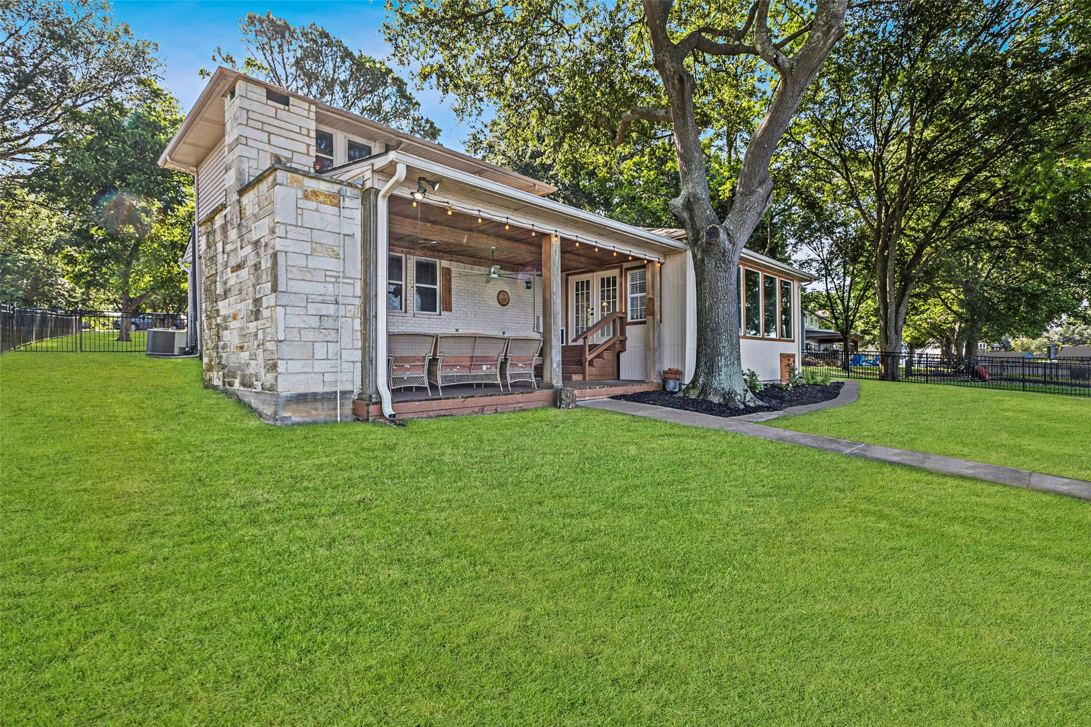 Private backyard with fenced green space and access to the dock.