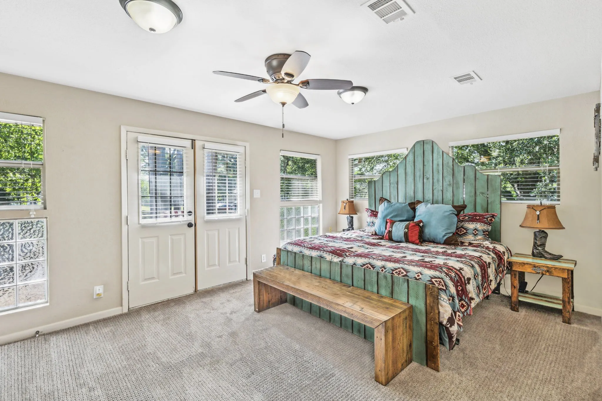 Primary bedroom with balcony and dual closets.