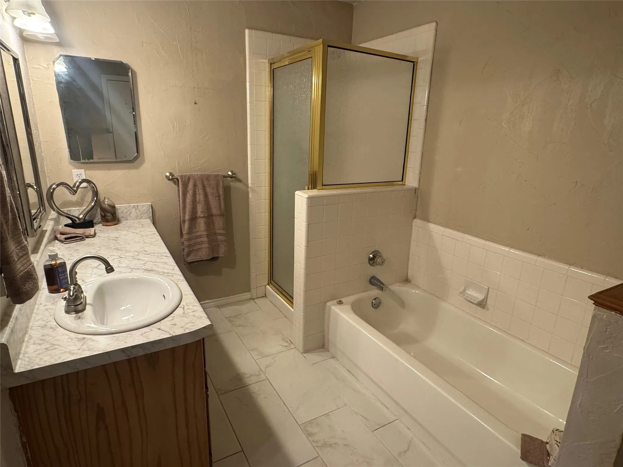 Ensuite bathroom with shower, tub, vanity, with large walk-in closet