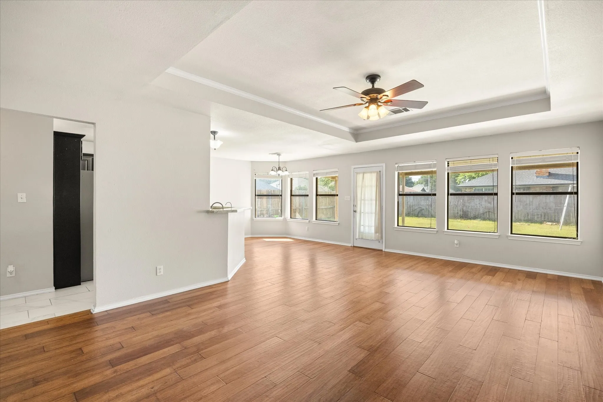 The wood floors in the living room are hardwood and made with pecan