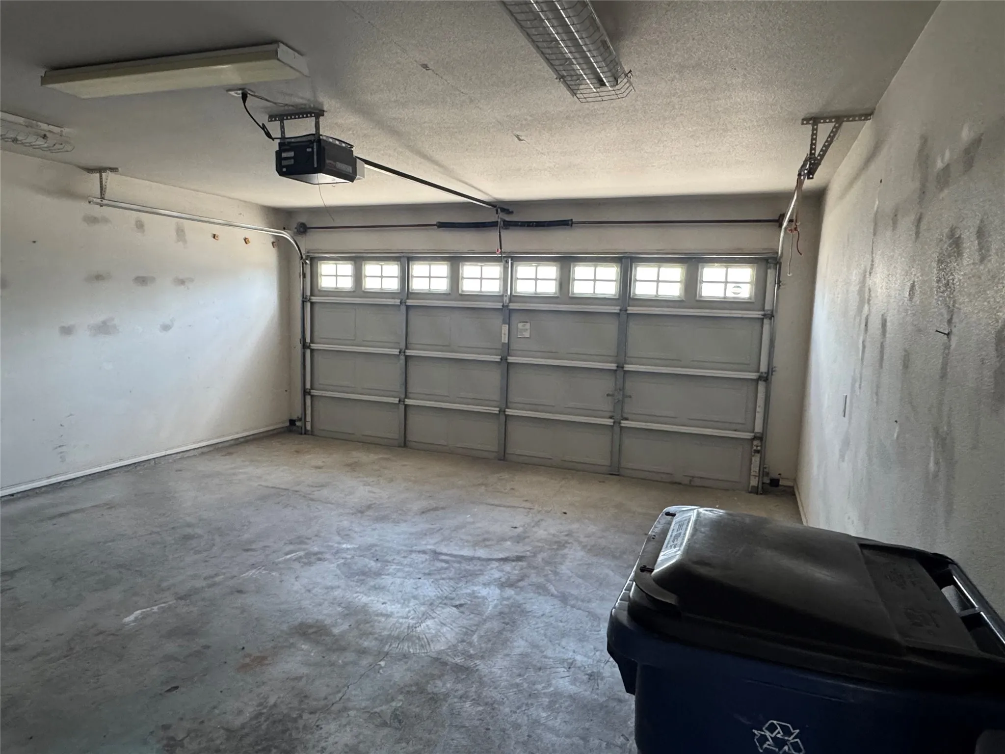 Garage door with openenr