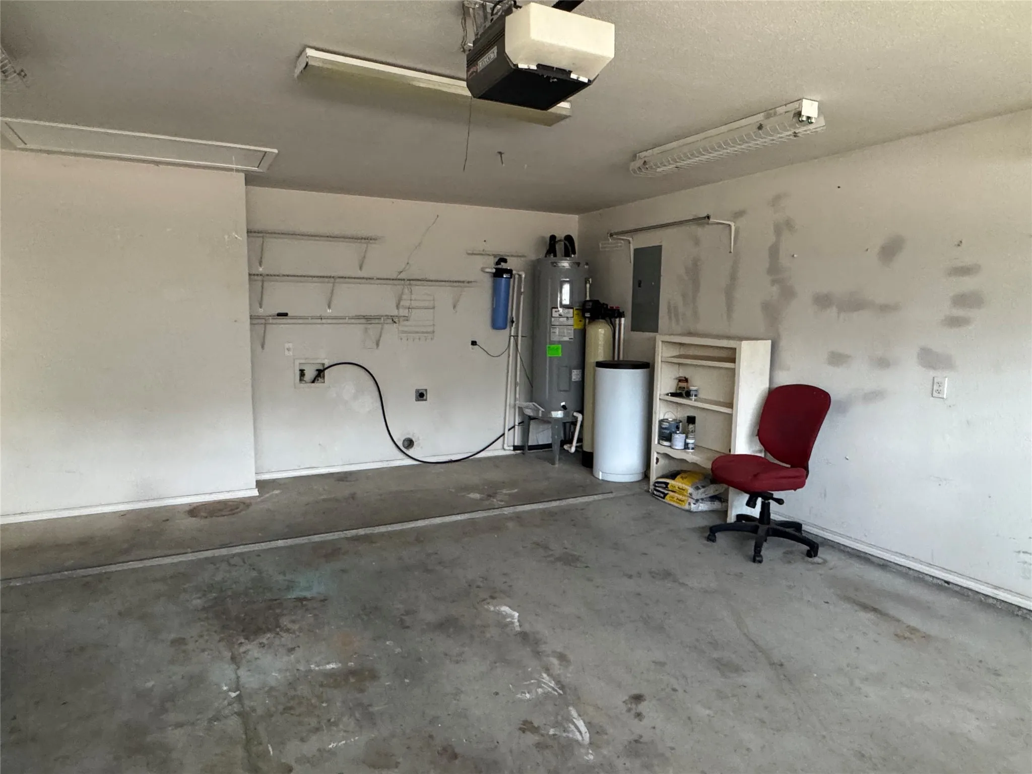 Laundry area with shelves in garage