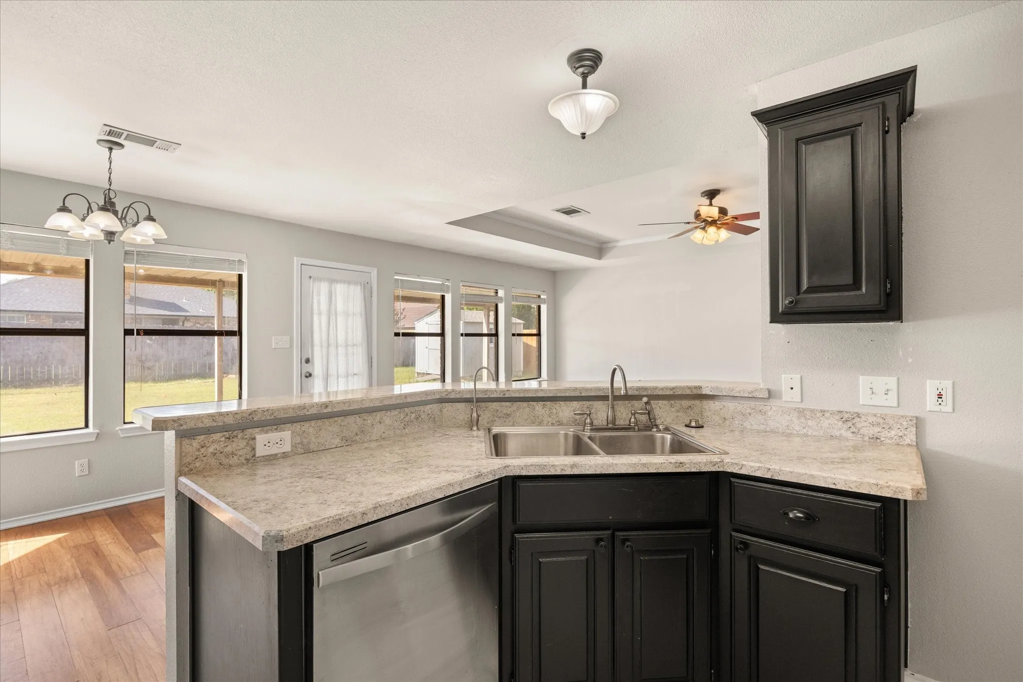 Kitchen sink overlooks living room and dining area