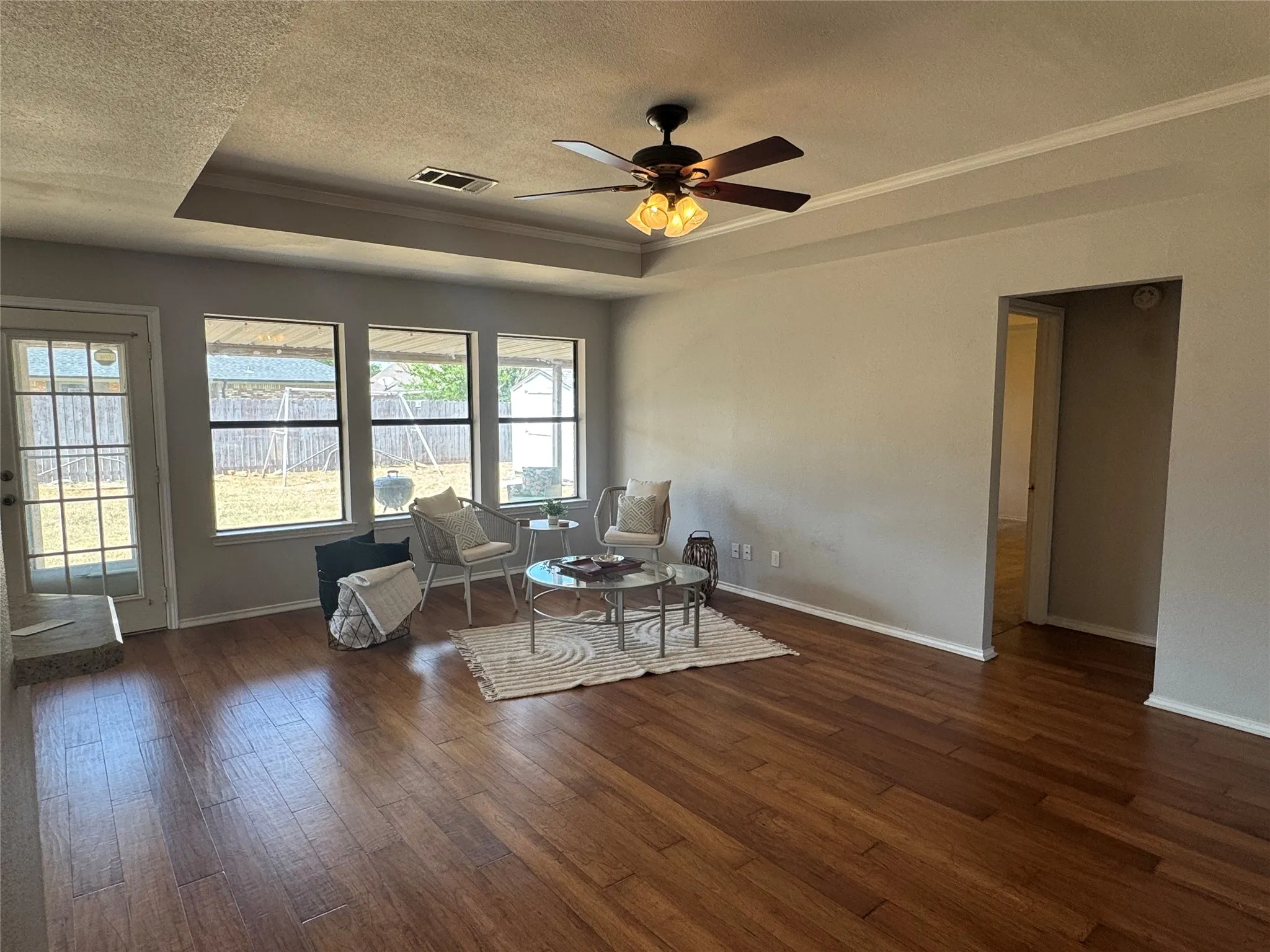 Large windows, ceiling fan, open concept living