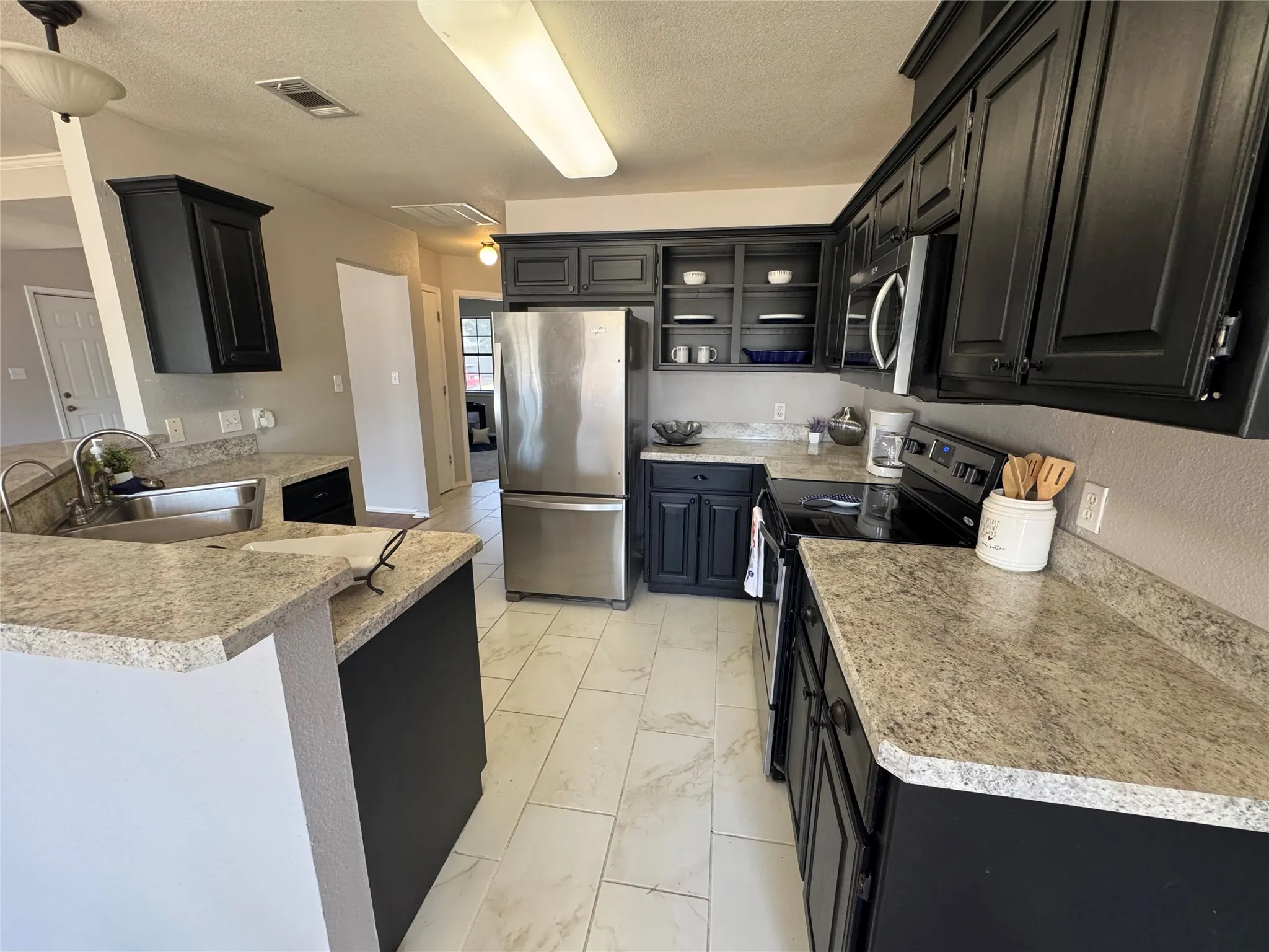 Tiled floors, lots of cabinets, ample counter space for meal prep