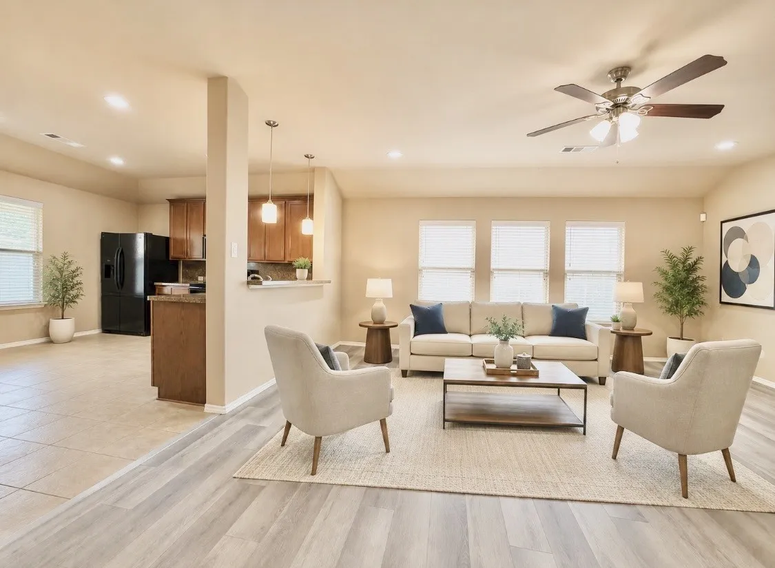 Virtually staged. Bright living area featuring light wood-finish flooring, recessed lighting, and a ceiling fan with light kit