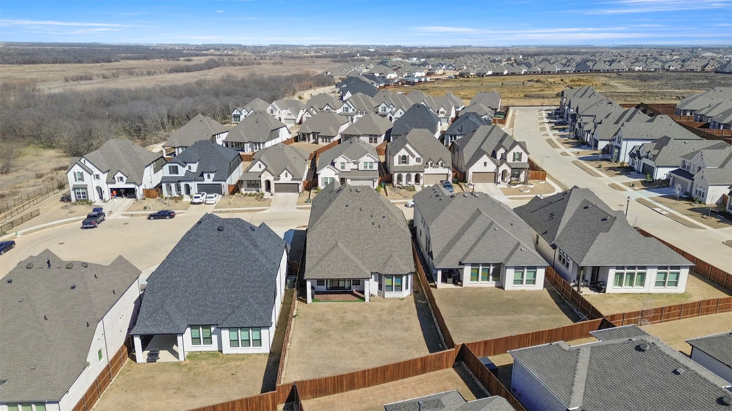 Beautiful view- large backyard and the wooded area off the front cul-de-sac