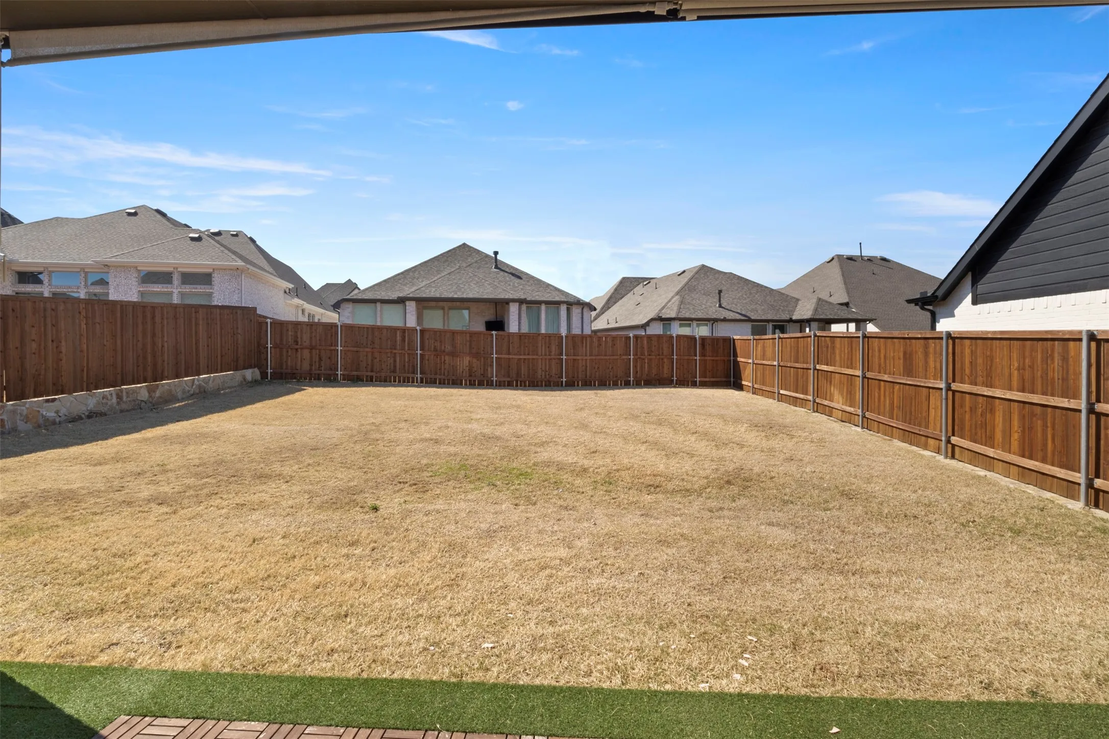Expansive backyard with a full perimeter wood fence