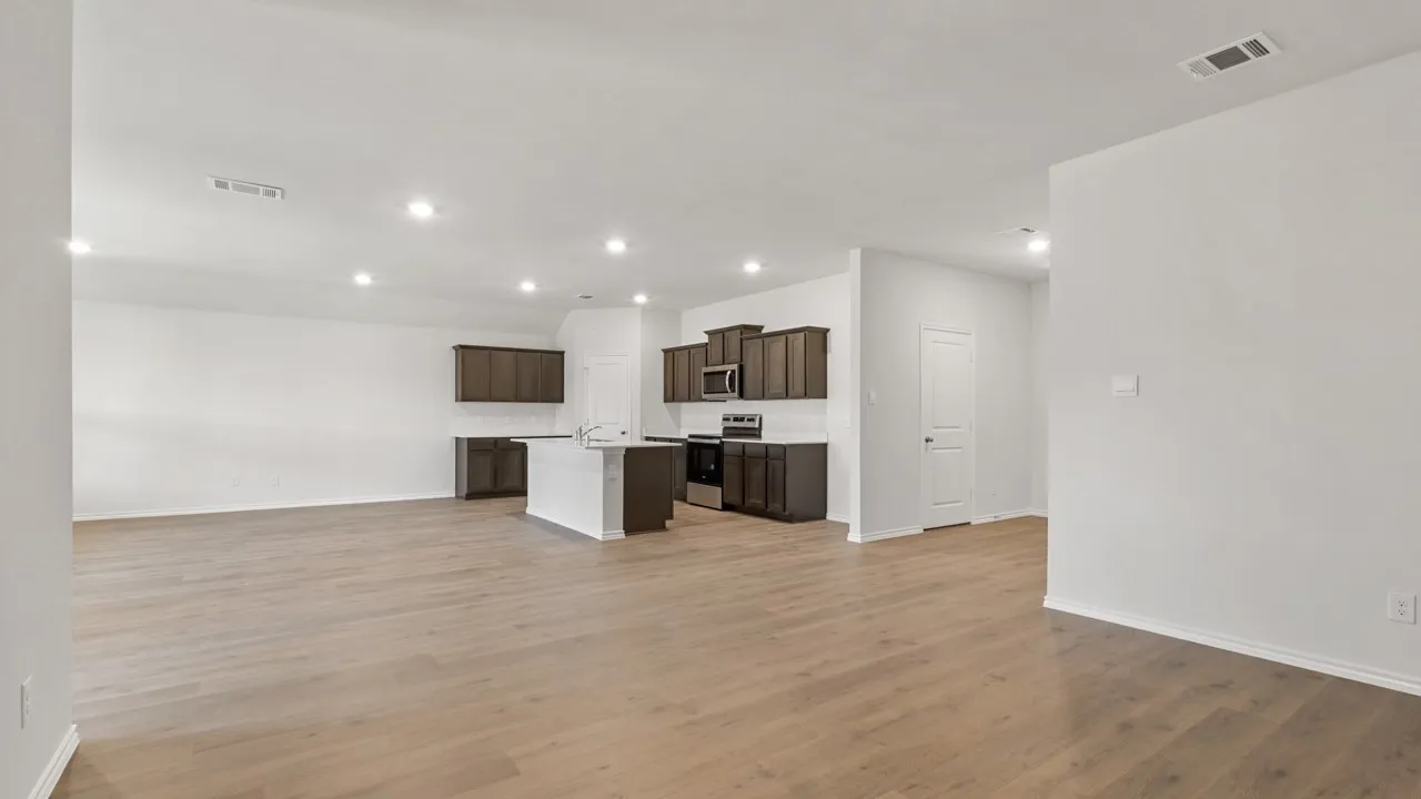 Open-concept living space featuring wood-finish flooring, recessed lighting, and a white color palette
