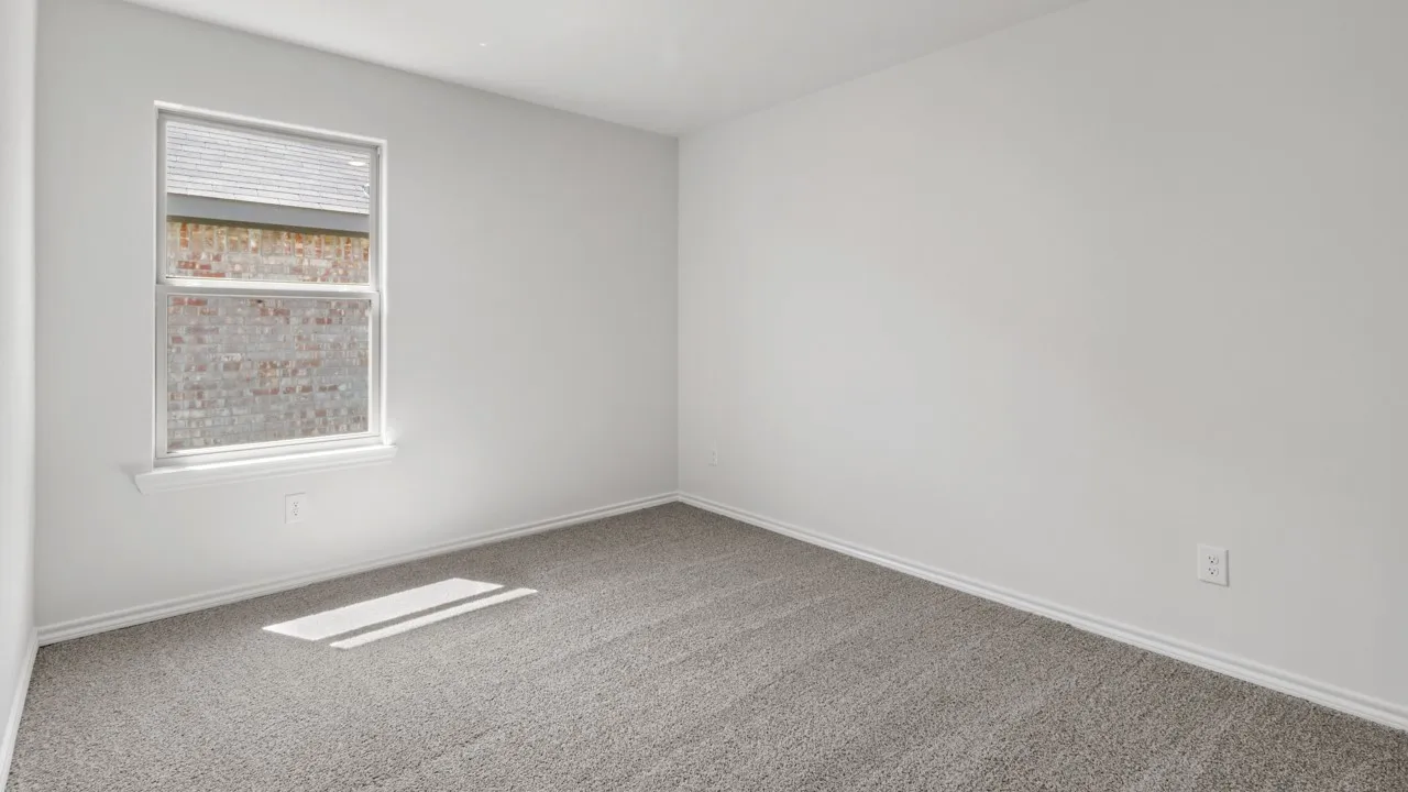 Room featuring neutral white walls and gray carpeting