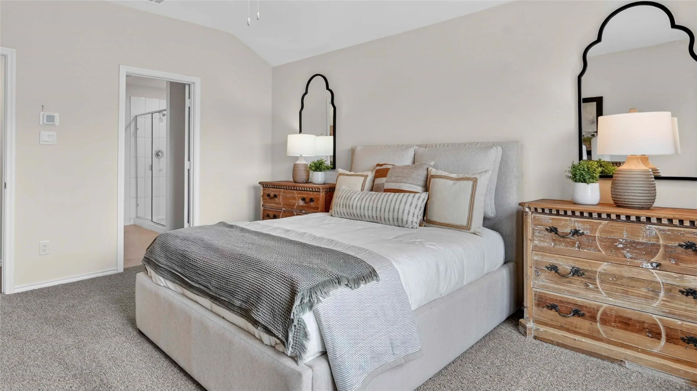 Vaulted ceiling bedroom with carpet flooring