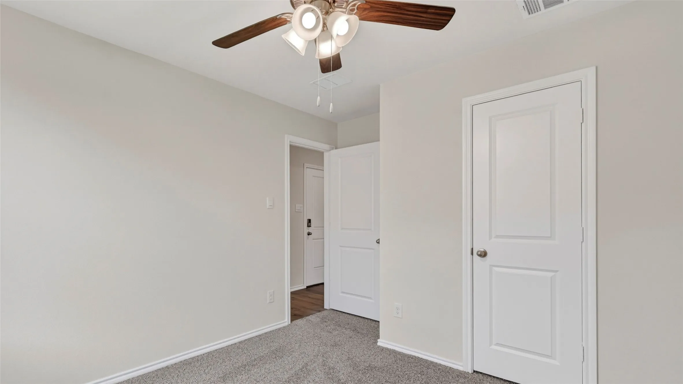 Neutral gray wall finishes complementing a gray carpeted floor