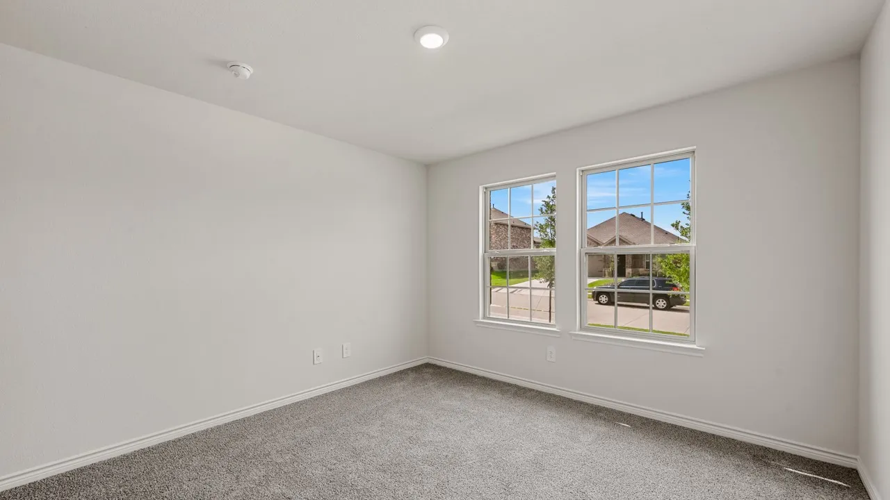 Interior room with light gray carpet flooring and white baseboards