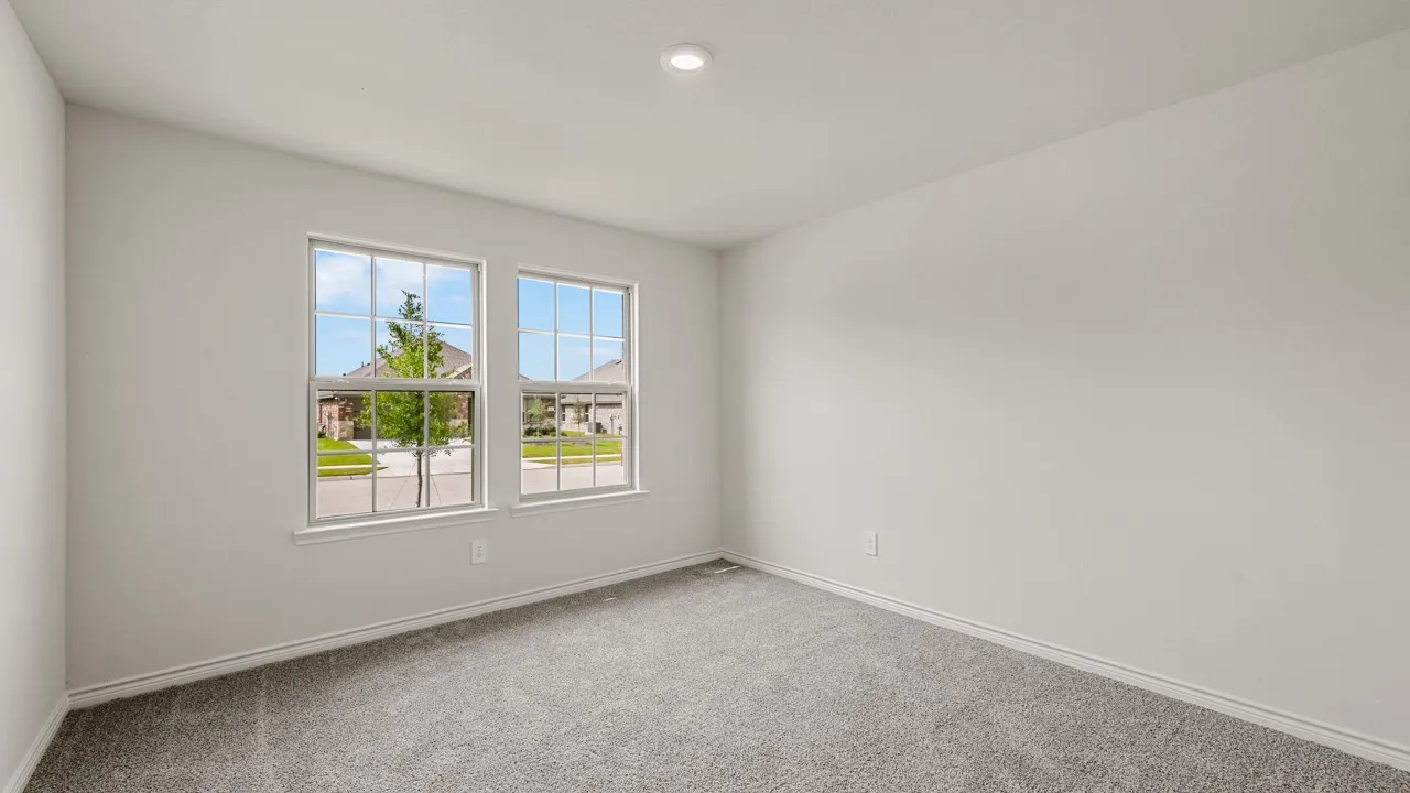 Light-filled interior space featuring two large paneled windows, neutral wall paint, recessed lighting, and grey carpeting