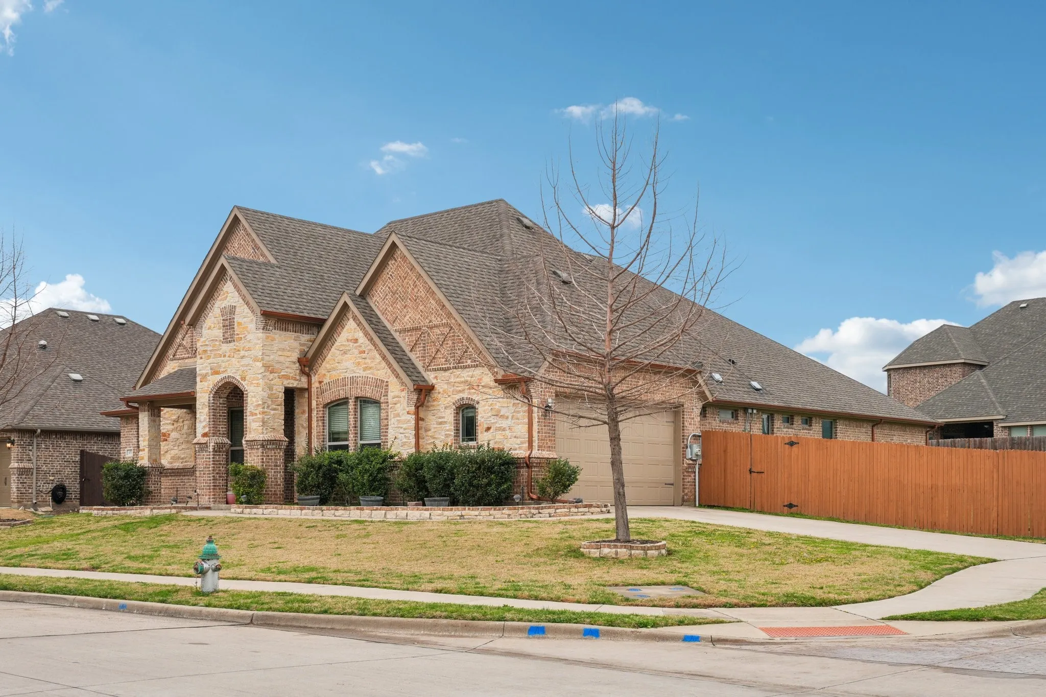 Side entry 2-car garage with spacious driveway parking.
