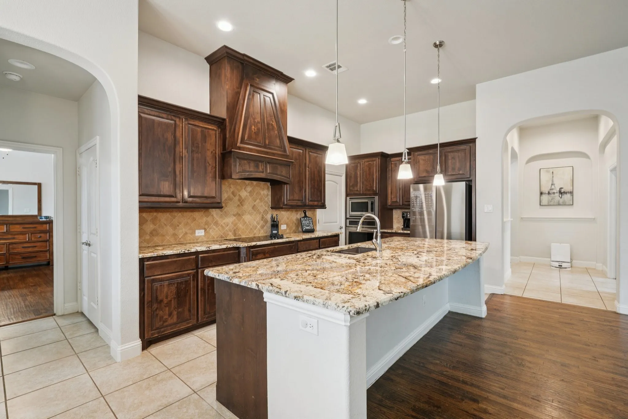 Kitchen featuring a large island and wood cabinetry.