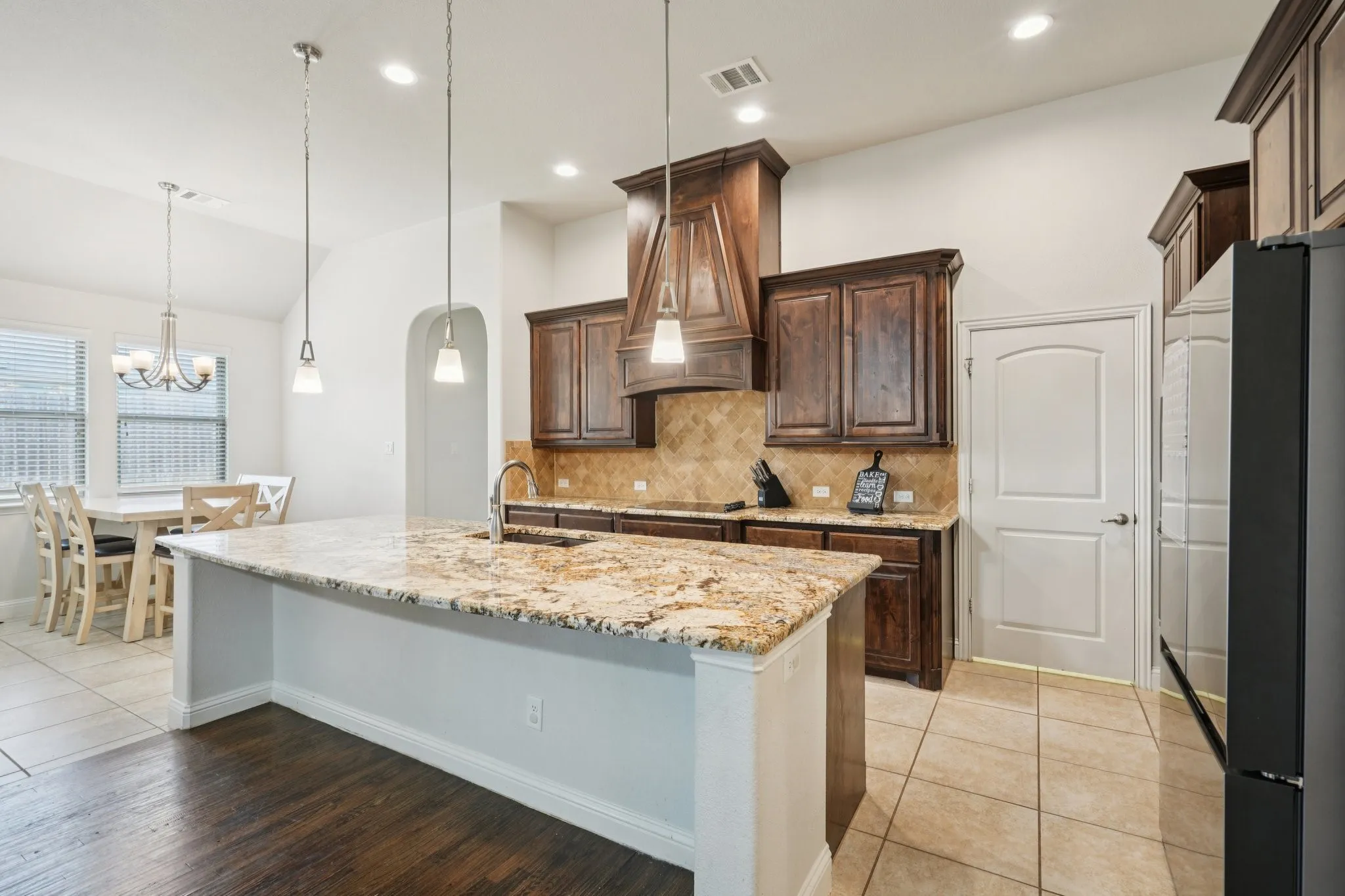 Additional view of the kitchen showcasing cabinetry, countertops, and layout.