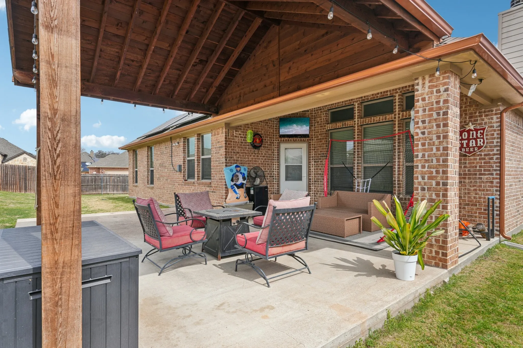 Covered patio with outdoor seating, ideal for relaxing and entertaining.