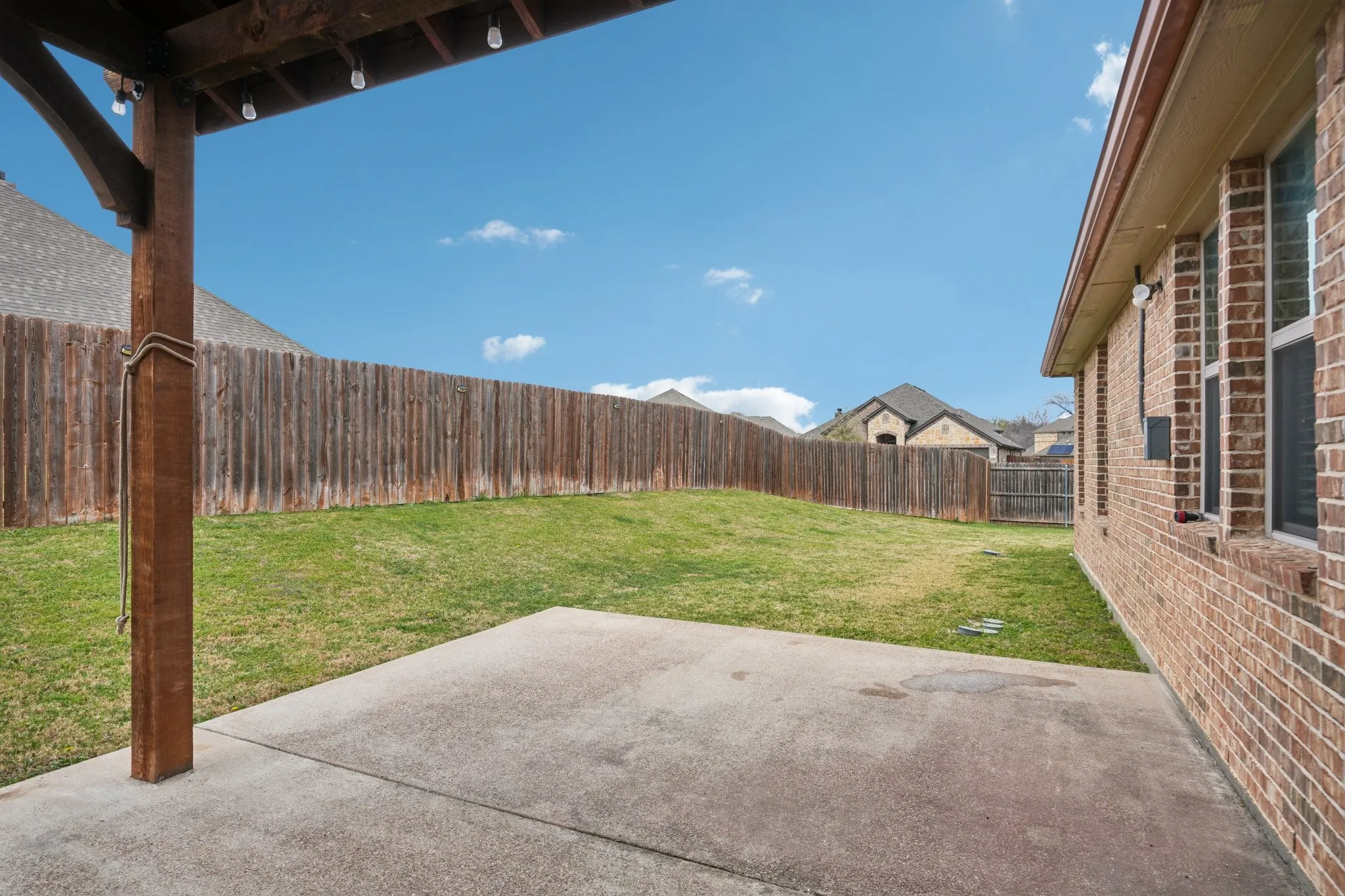 Covered patio with outdoor seating, ideal for relaxing and entertaining.